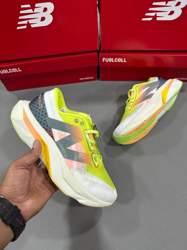 New Balance FuelCell SuperComp Elite v3 running shoe with lime yellow, white, grey, and orange details, featuring vibrant upper and performance sole."
