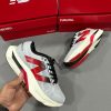 New Balance FuelCell SuperComp Elite v3 in white and grey with striking red and black features, perfect for runners seeking both style and speed.
