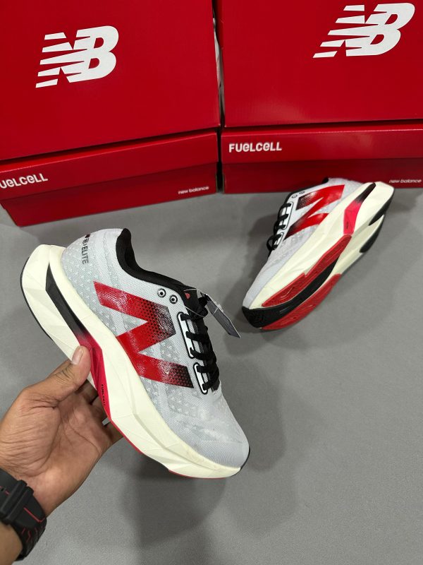 New Balance FuelCell SuperComp Elite v3 in white and grey with striking red and black features, perfect for runners seeking both style and speed.