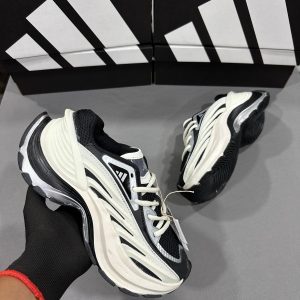 Adidas Response CL style sneaker in black, white, and cream colorway with chunky wavy sole, mesh and synthetic upper