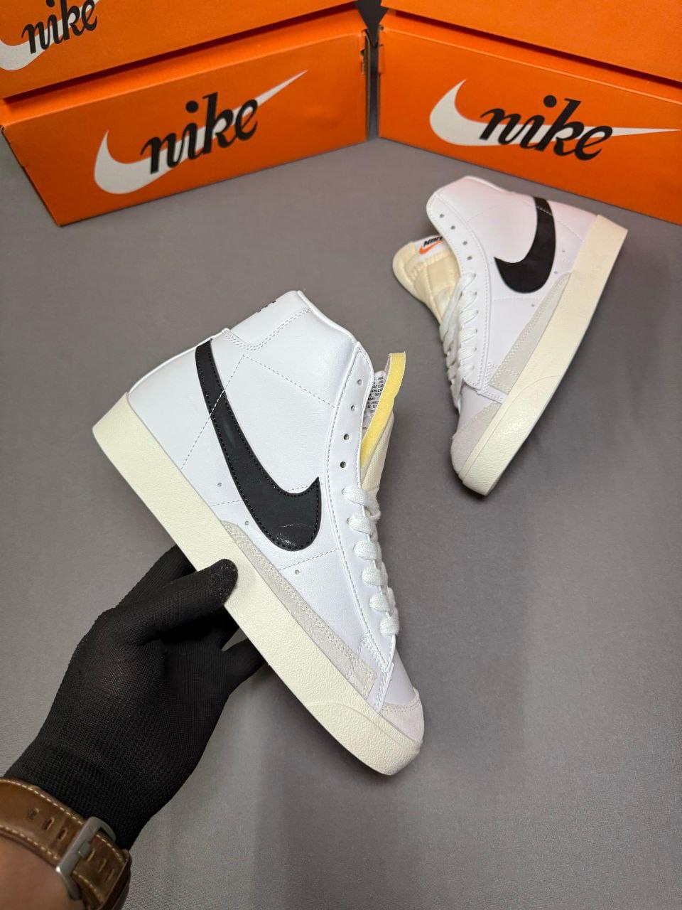 Experience a perfect blend of vintage aesthetics and modern streetwear with the Nike Blazer Mid 77 Vintage White Black First Copy Shoes from Martify. Designed for sneaker lovers who crave both iconic style and unbeatable value, these first copy shoes offer a premium look that mirrors the original. With clean white uppers, contrasting black swoosh, and classic mid-cut design, they’re ideal for everyday wear or styling up your sneaker rotation. Whether you're hitting the streets or chilling with friends, these shoes bring comfort, durability, and timeless Nike style—without breaking the bank. Elevate your sneaker game with this best-in-class replica at an unbeatable price.