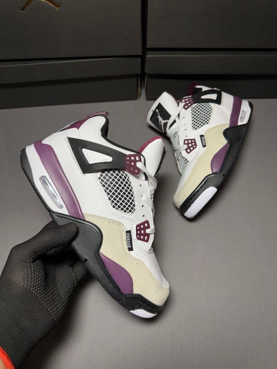 Nike Air Jordan Retro 4 PSG First Copy Shoes in white, beige, and burgundy held by hand against a dark background